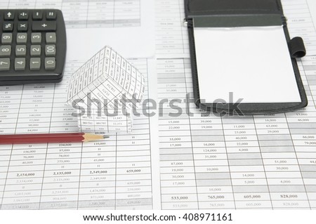 Brown pencil and house on finance account have blur calculator and notepad as background with copy space. Stack document of account as work hard. Business and finance concepts rich and successful.