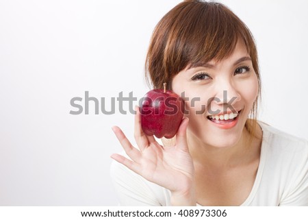 healthy asian woman with red apple, looking at you