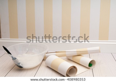 Home improvement scene of wallpaper being prepared to hang on the wall Royalty-Free Stock Photo #408980353