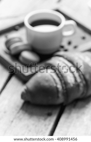 fresh croissant and coffee/blur photo