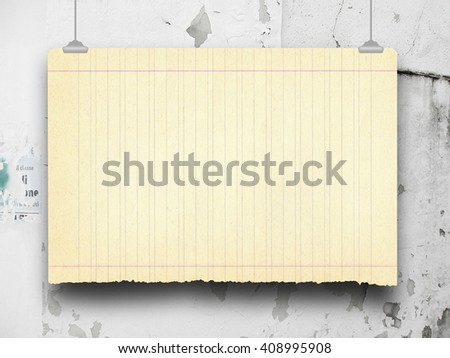 Close-up of one blank old paper sheet frame hanged by clips against grey scratched concrete wall background