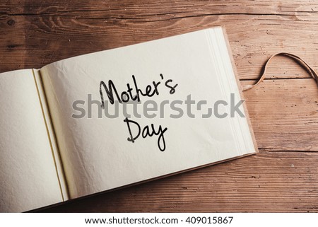 Mothers day sign. Photo album. Studio shot, wooden, background.