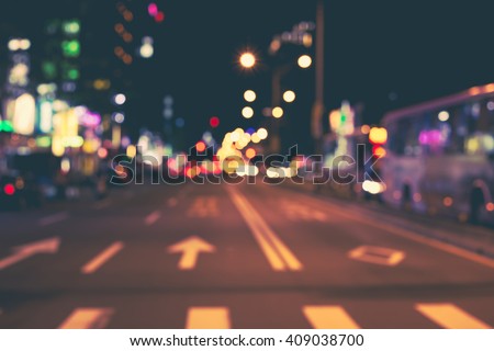 Blurred image of city at night. De focused, blurred urban abstract traffic background. Night city background.