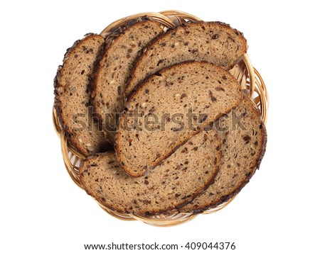 Sliced bread with sunflower seeds, raisins and nuts in plate isolated on white background, top view Royalty-Free Stock Photo #409044376