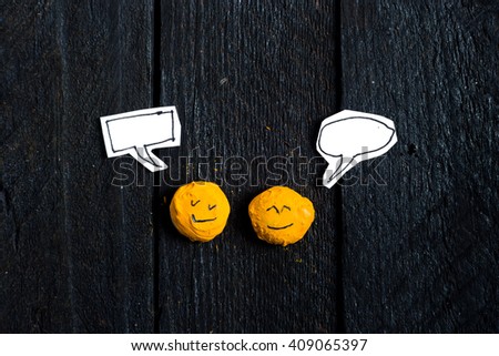 Two smile face talking on vintage table with talking box. 