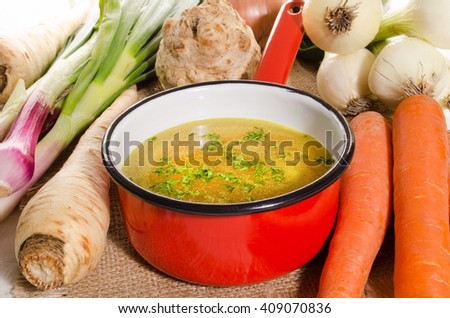 cooled vegetable stock in a red enamel pot
