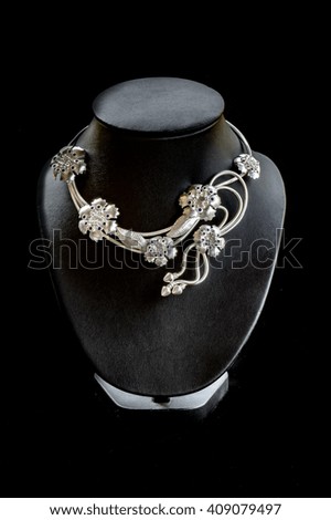 Silver necklace worn by the black mannequins.