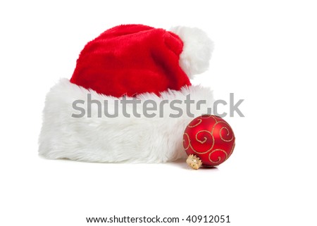 Santa hat and a red glittery christmas ball on a white background