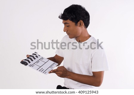 young man holding film slate on white background. (film production and movie making concept)