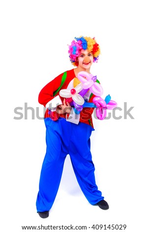 Funny playful girl clown in colorful wig holding a balloon flowers, isolated on a white background. Clown in the costume