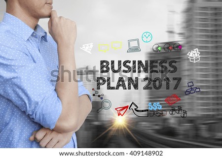 young man stand and thinking with business plan 2017  text ,business concept 