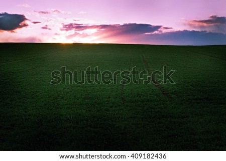 dark picture of emotional sunset over the horizon verdant fields in Ceske stredohorie in bohemian landcape
