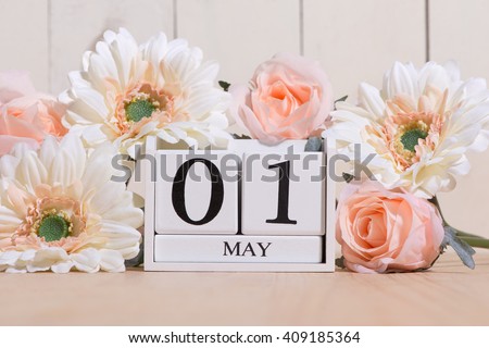 May 1st. Image of may 1 white block calendar on white background with flowers. Spring day, empty space for text. International Workers' Day Royalty-Free Stock Photo #409185364