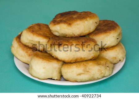 Potato cakes with meat on a green background