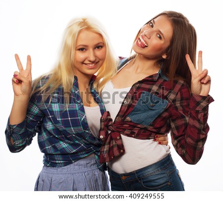 two young girl friends standing together and having fun