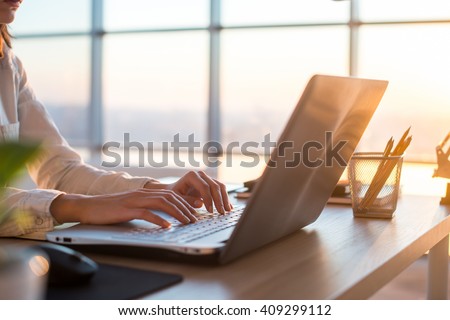 Adult businesswoman working at home using computer, studying business ideas on a pc screen on-line. Royalty-Free Stock Photo #409299112