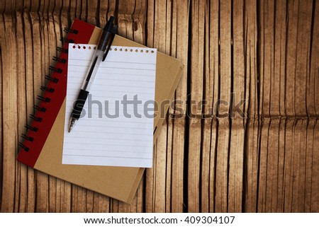 pen and notepad on old bamboo floor background
