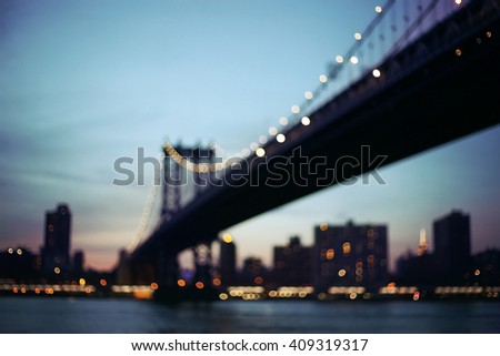 Out of focus view of Manhattan bridge at sunset. Manhattan New York. Urban living and transportation concept. Vintage color post processed