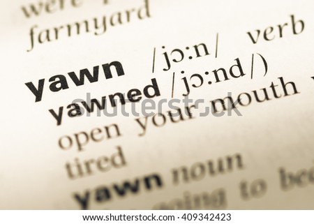 Close up of old English dictionary page with word yawn