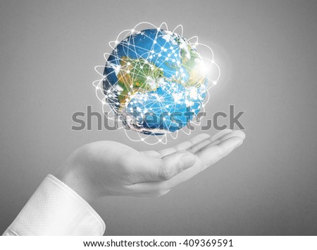 Human hand holding globe Elements of this image furnished by NASA