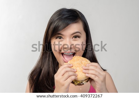 A girl eating a hamburger
