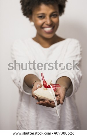 Cute black woman receiving a gift.