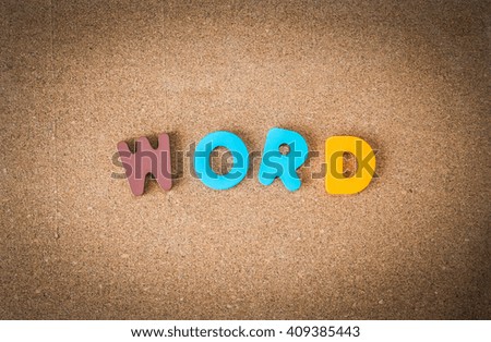 Colorful wooden WORD on cork board