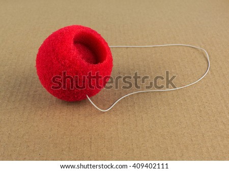 church attributes. red clown nose with elastic on the vintage background. Royalty-Free Stock Photo #409402111