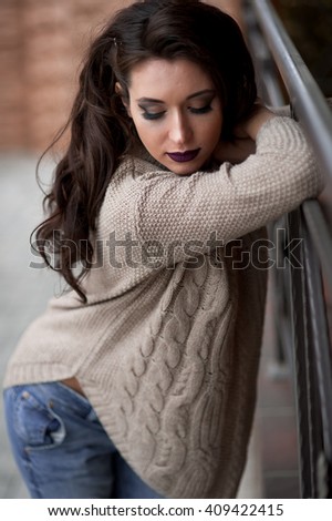 Spring in the country style. Full length portrait of young woman in knitted sweater 