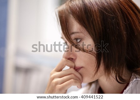 Beautiful girl in the office sitting in a chair and thinks about something Royalty-Free Stock Photo #409441522