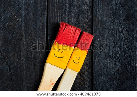 Colored brushes smile fun and happy as toy character.  Brushes round and his hair colored in red.