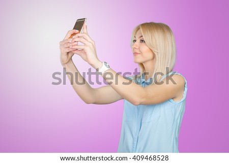 teenage girl making selfie photo with smart phone
