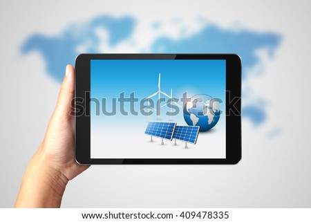 Clean Energy Concept, Hand holding digital tablet with solar energy panels and wind turbine on display