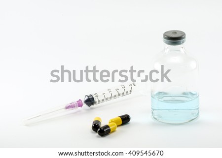 Ampules and needle for vaccination on white background.
