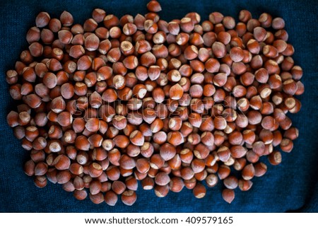 Stack of hazelnuts. Hazelnut background, selective focus