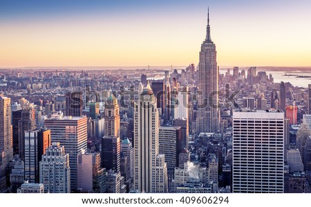Aerial view of Manhattan in New York city, USA with its famous skyscrapers and light on a sunny sunset.