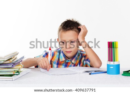 Tired school boy doing homework