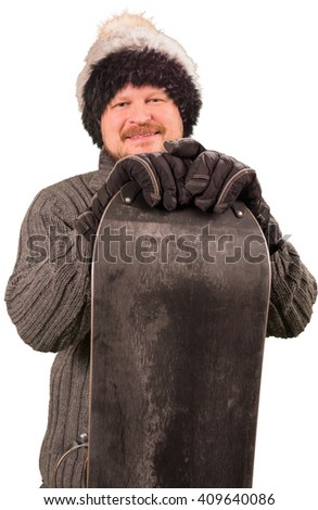 Man in sweater standing with snowboard