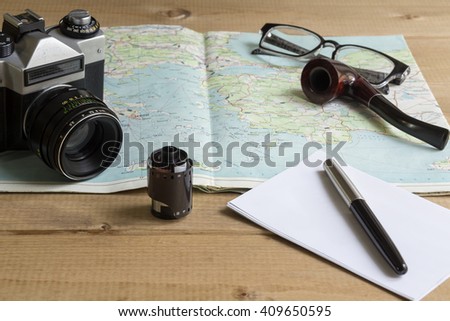 vintage camera and film on a map on the table
