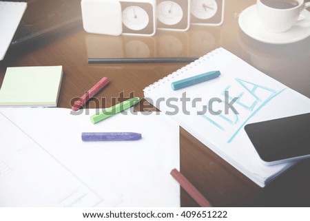 idea on notebook,pencil,coffee,clock on table