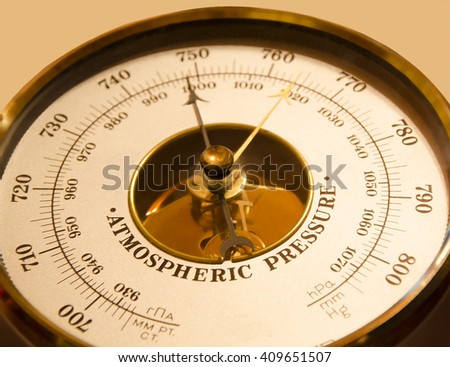 Atmospheric pressure of a barometer on a beige background weather atmospheric pressure climate weather Royalty-Free Stock Photo #409651507