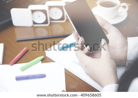woman hand phone, idea writing on notebook,pencil,coffee,glasses on table