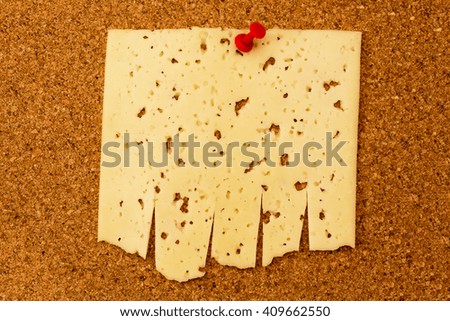 Yellow slice of cheese with push pin note pinned on cork board background,  post-it note text place, frame 