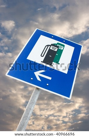 Petrol station traffic sign against cloudy sky