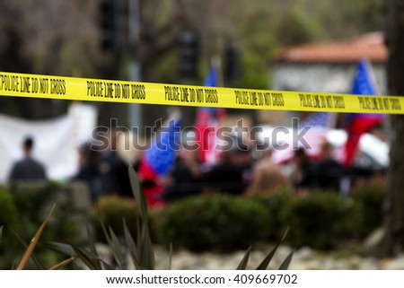 Police line tape used for crowd control at a peaceful protest. Royalty-Free Stock Photo #409669702
