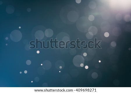 Abstract bokeh light on black background with flare. Christmas concept to present celebration wallpaper decor with beautiful glitter and sparkle bubbles in blur or defocus style for web design.
