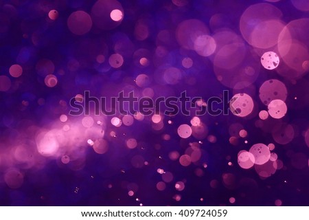 Purple bokeh abstract background caused by spray water. Royalty-Free Stock Photo #409724059