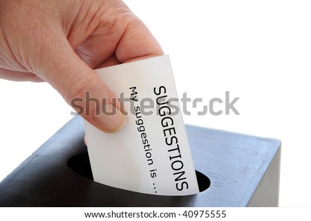 Hand placing a suggestion slip into a box against a white background