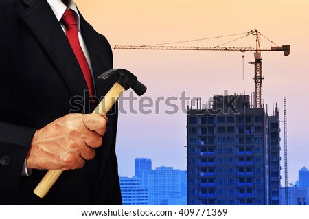 business man hold hammer , labor day concept background