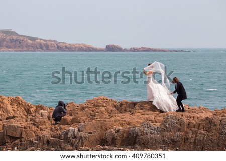 Wedding photography at the coast of Qingdao with a bride being prepared and photographed